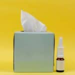 a saline nasal rinse next to facial tissues