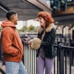 a new couple talking outdoors