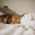 someone on bed oversleeping
