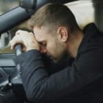 someone driving with head tension