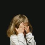a young kid with head tension