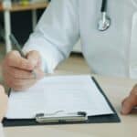 a doctor writing notes down