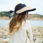 woman wearing hot looking out on water