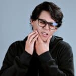 man feeling tension in jaw
