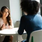 two people talking at table