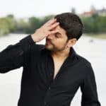man with migraine tension nausea