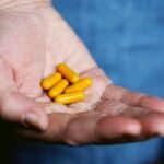 supplement pills in hand