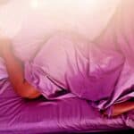 woman laying down in bedding