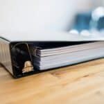 a binder with papers documents migraine