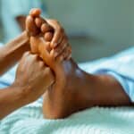 a foot massage with hands